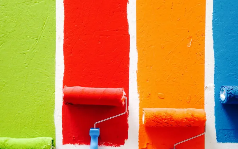 Paint rollers in four bright colours