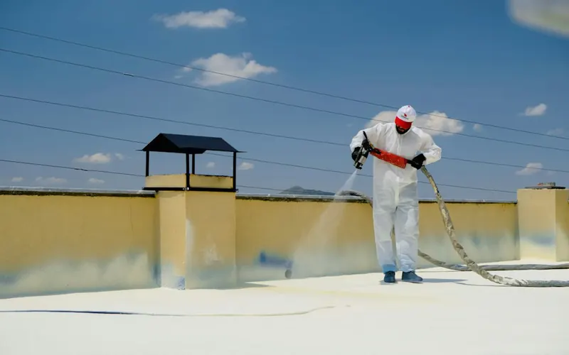 Waterproof coating being sprayed on a roof terrace